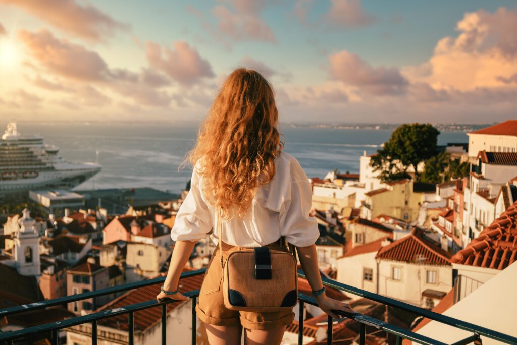 a woman standing on a balcony overlooking a city